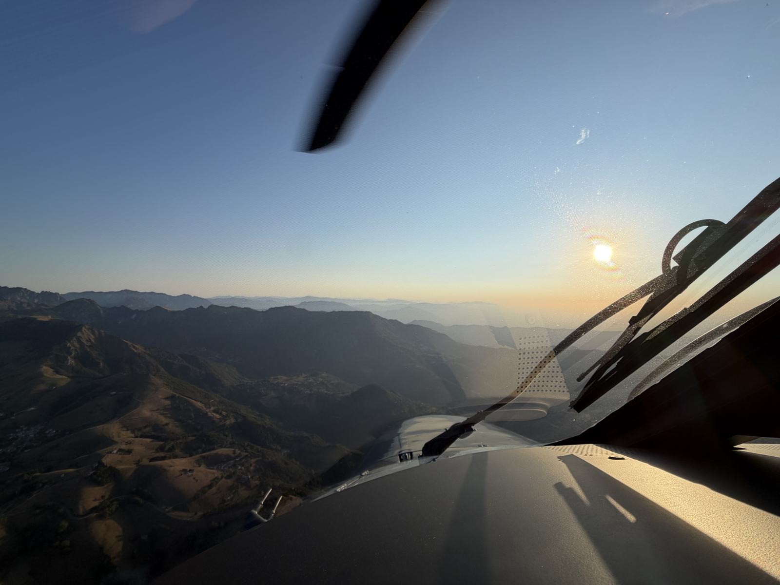 Low sun over the hills, seen from the cockpit